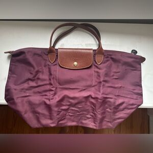 Used Large pliage longchamp bag. Short Handle. Purple. Authentic. Used.